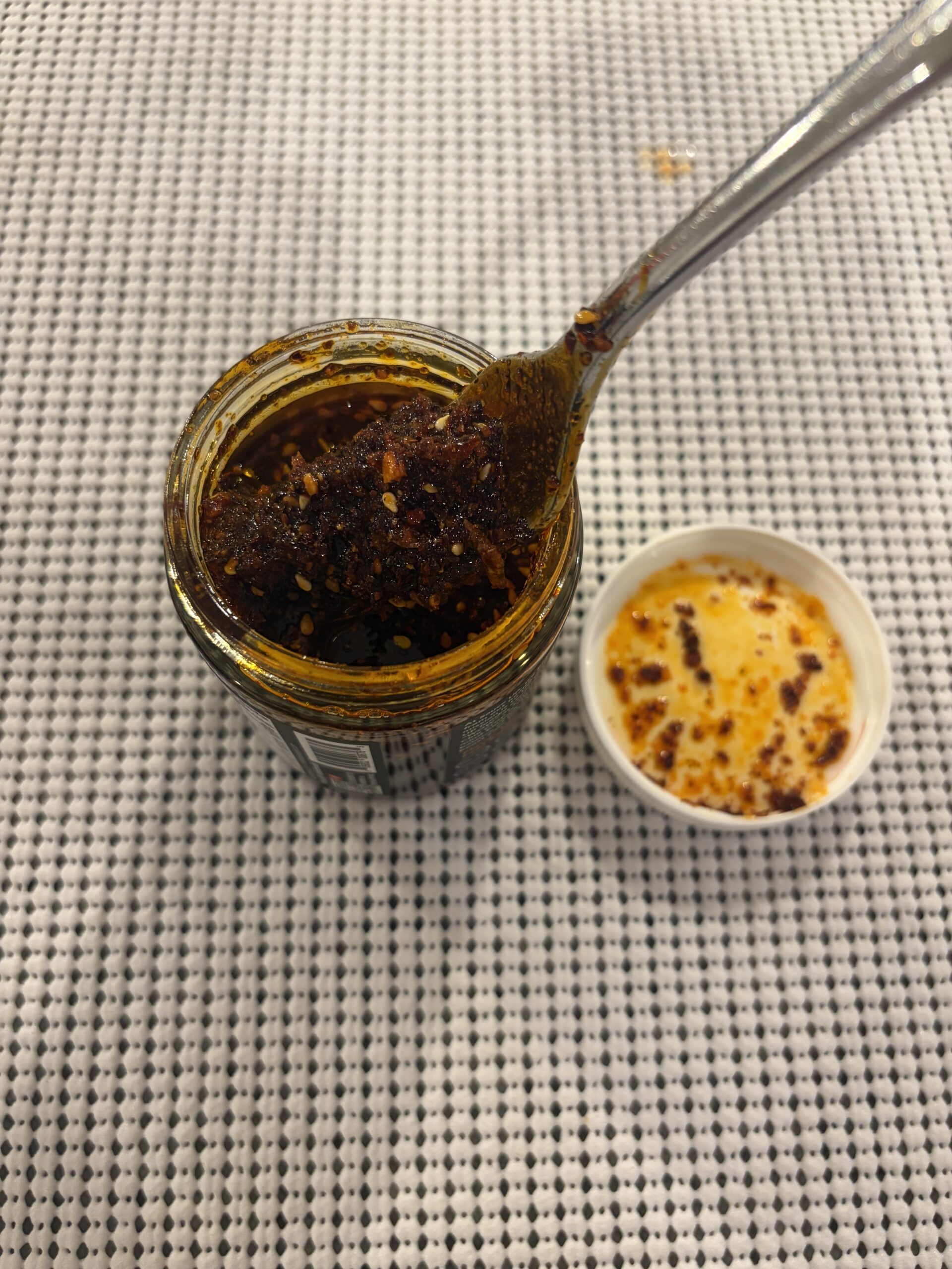 Sauce Up chili crisp post-stir texture showing finely ground bits — Flavor Index Lab