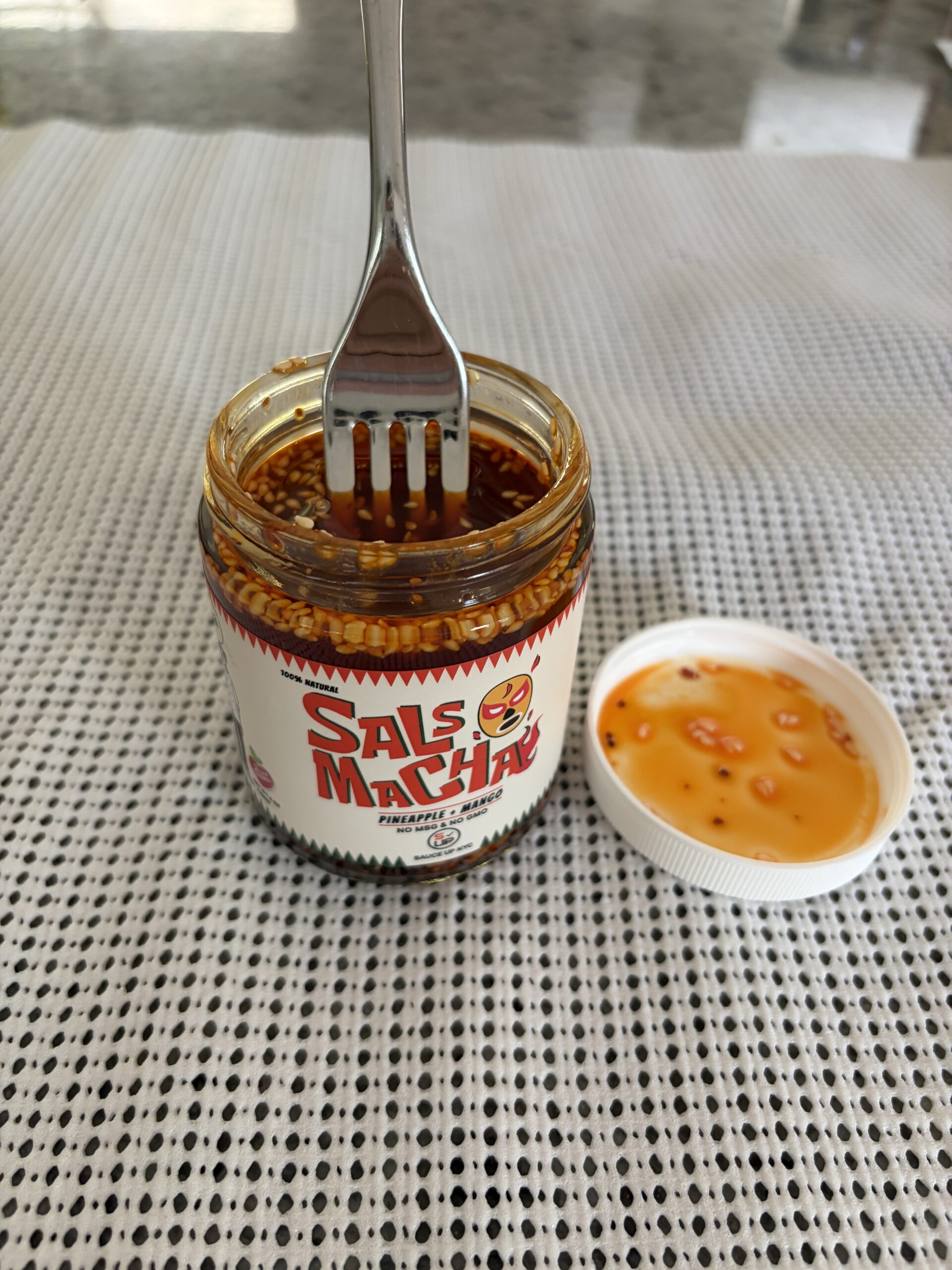 Fork sitting on Sauce Up Pineapple Mango salsa macha solids — Flavor Index Lab