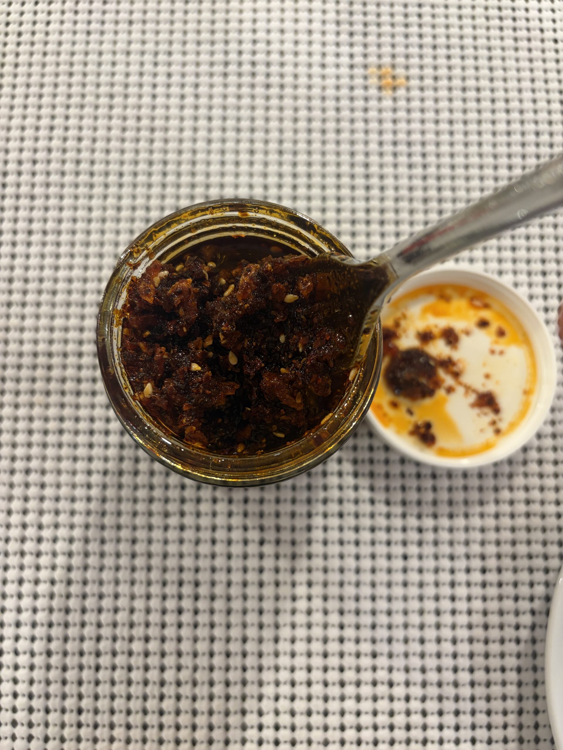 Sauce Up White Truffle chili crisp fork stir with dark red oil and seasonings — Flavor Index Lab