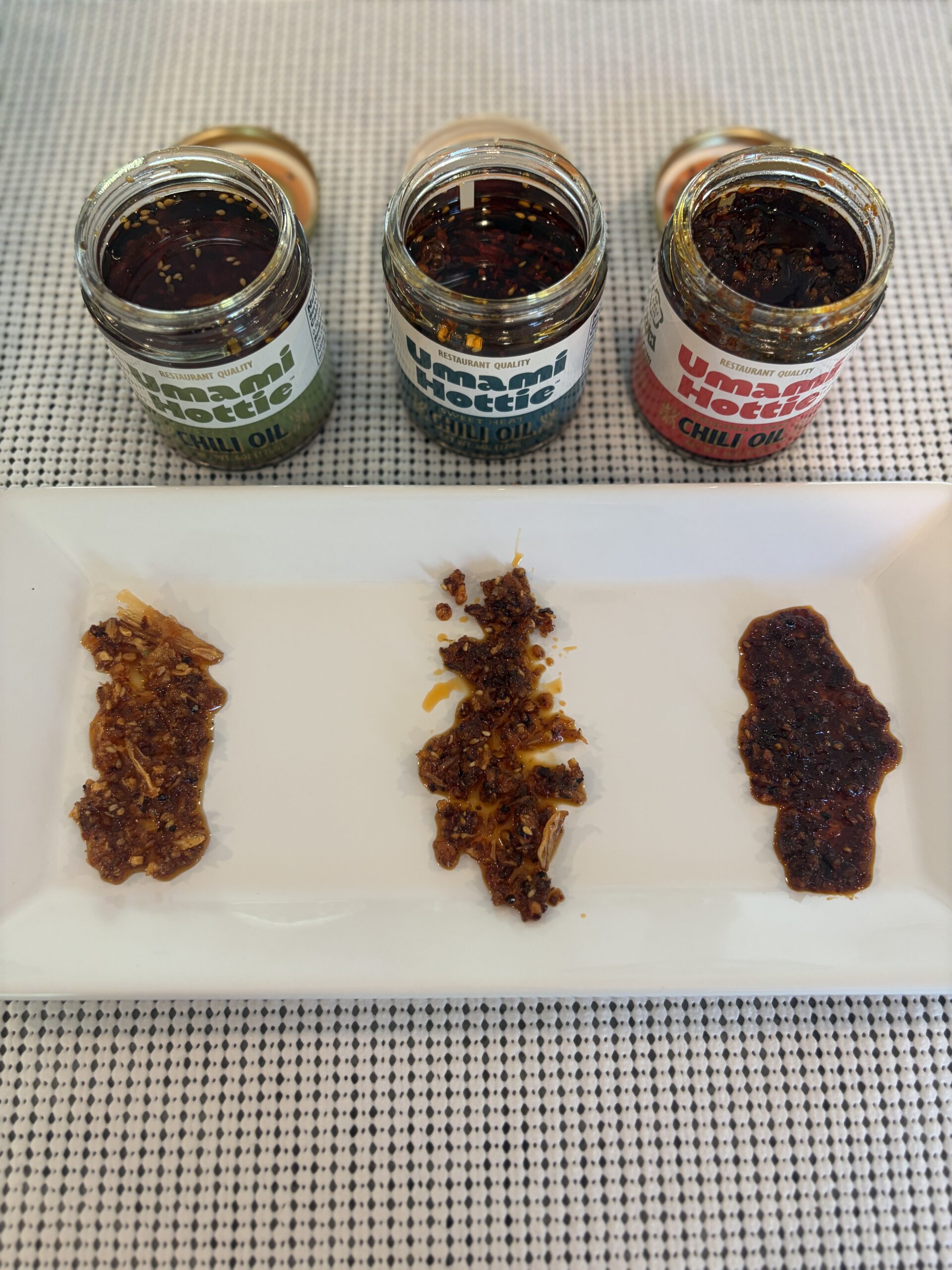 Three Umami Hottie chili oil varieties open and plated side by side — Flavor Index Lab