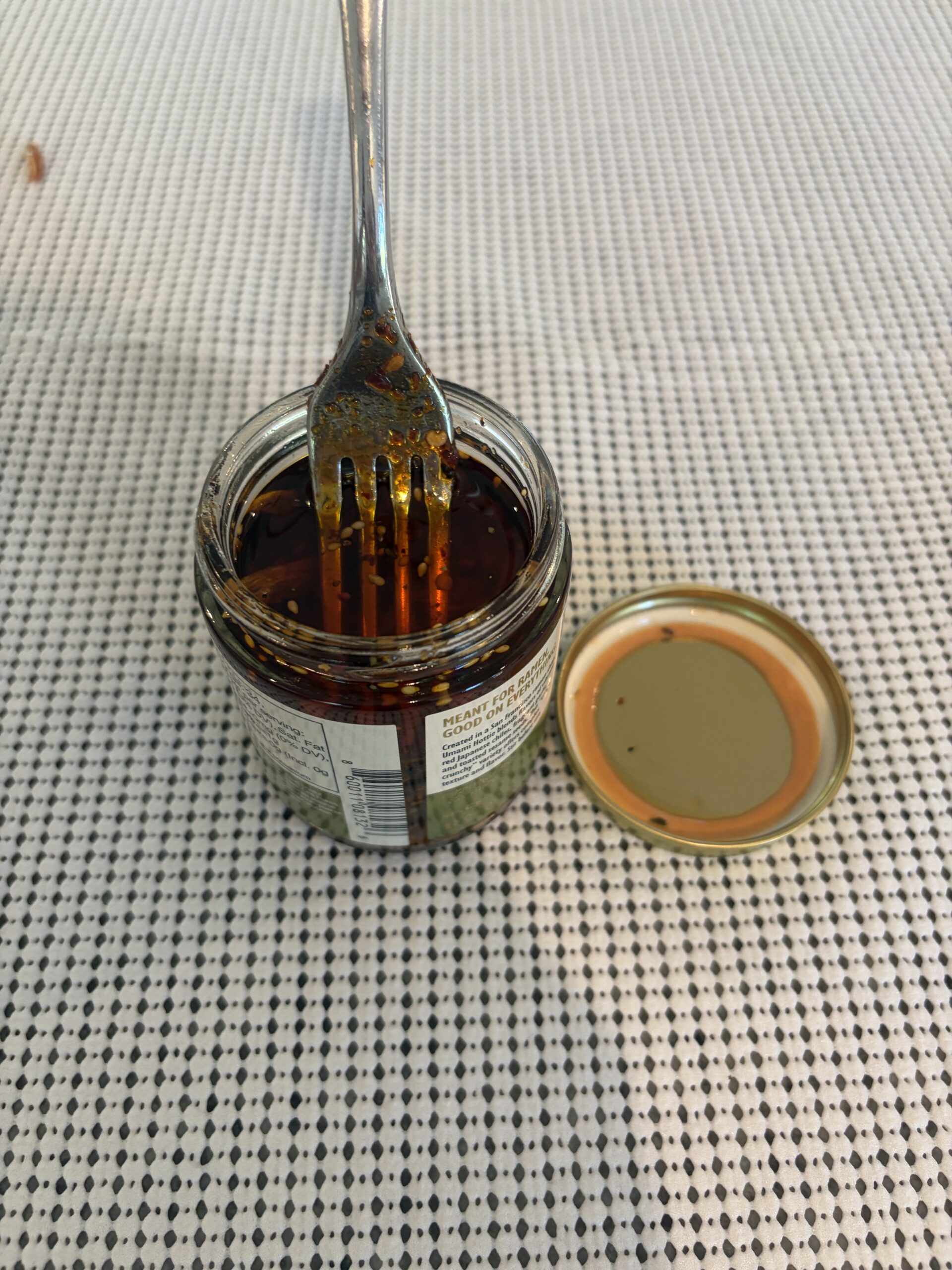 Umami Hottie Crispy Crunchy chili oil review fork resting on dense fried garlic and shallot solids — Flavor Index Lab