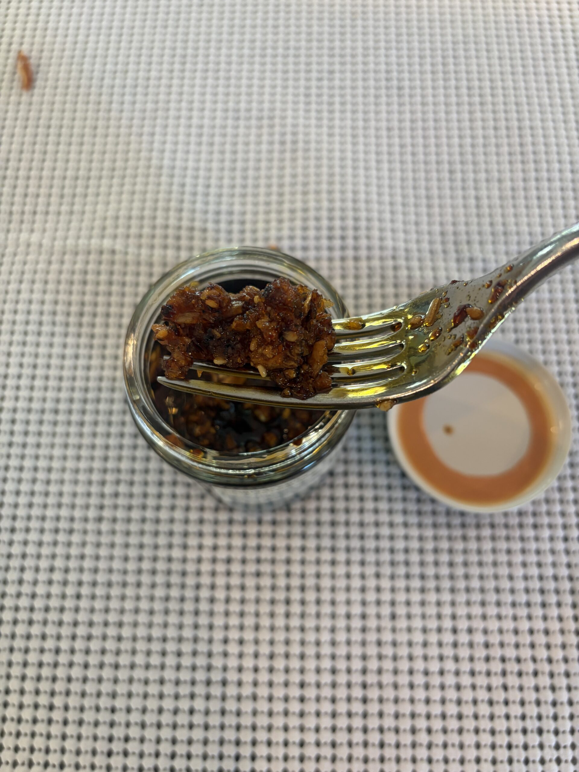 Umami Hottie chili oil fork pull showing chewy texture — Flavor Index Lab