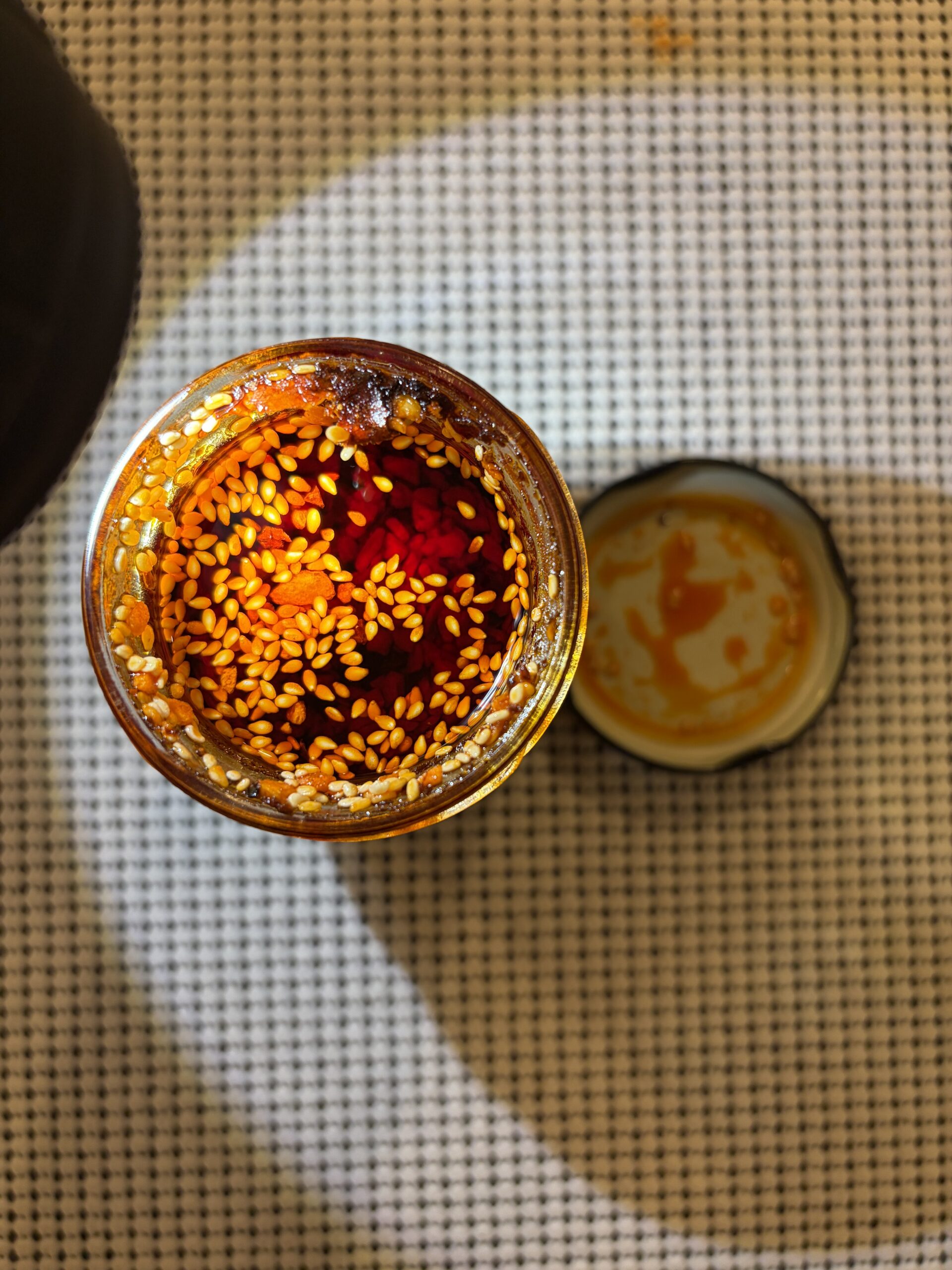 WUJU Sweet Heat chili crisp open jar showing chili flakes and sesame seeds — Flavor Index Lab