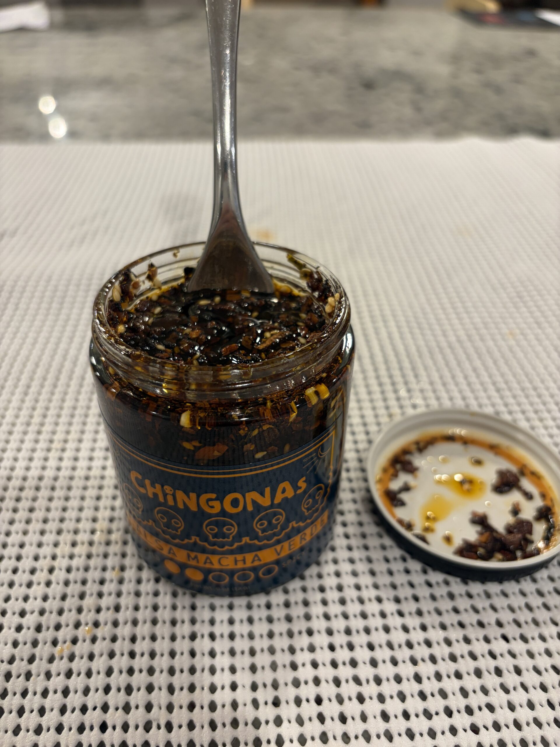 Fork resting on CHiNGONAs Salsa Macha Verde solids — Flavor Index Lab