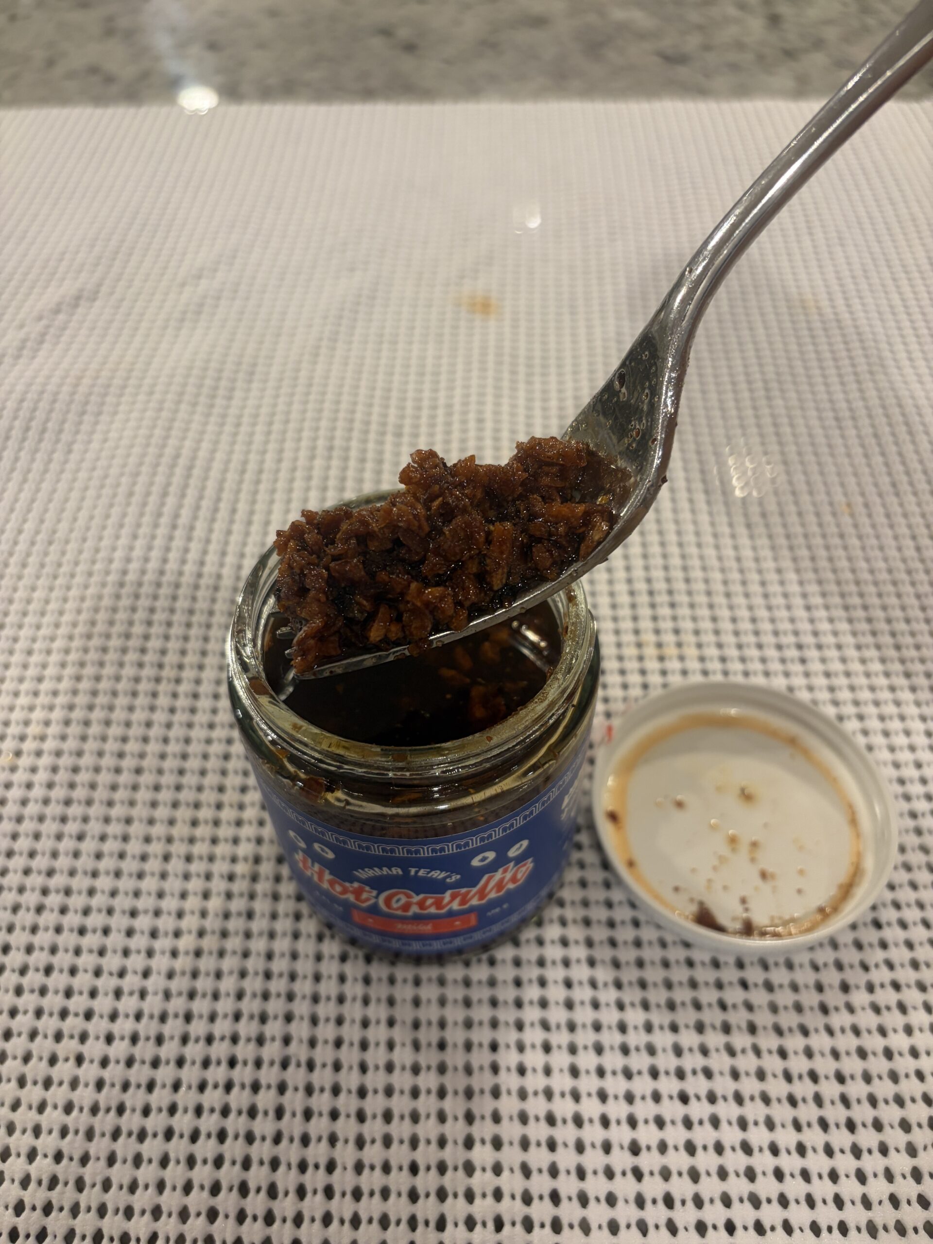 Mama Teav's Mild chili crisp second fork pull with fried garlic texture — Flavor Index Lab