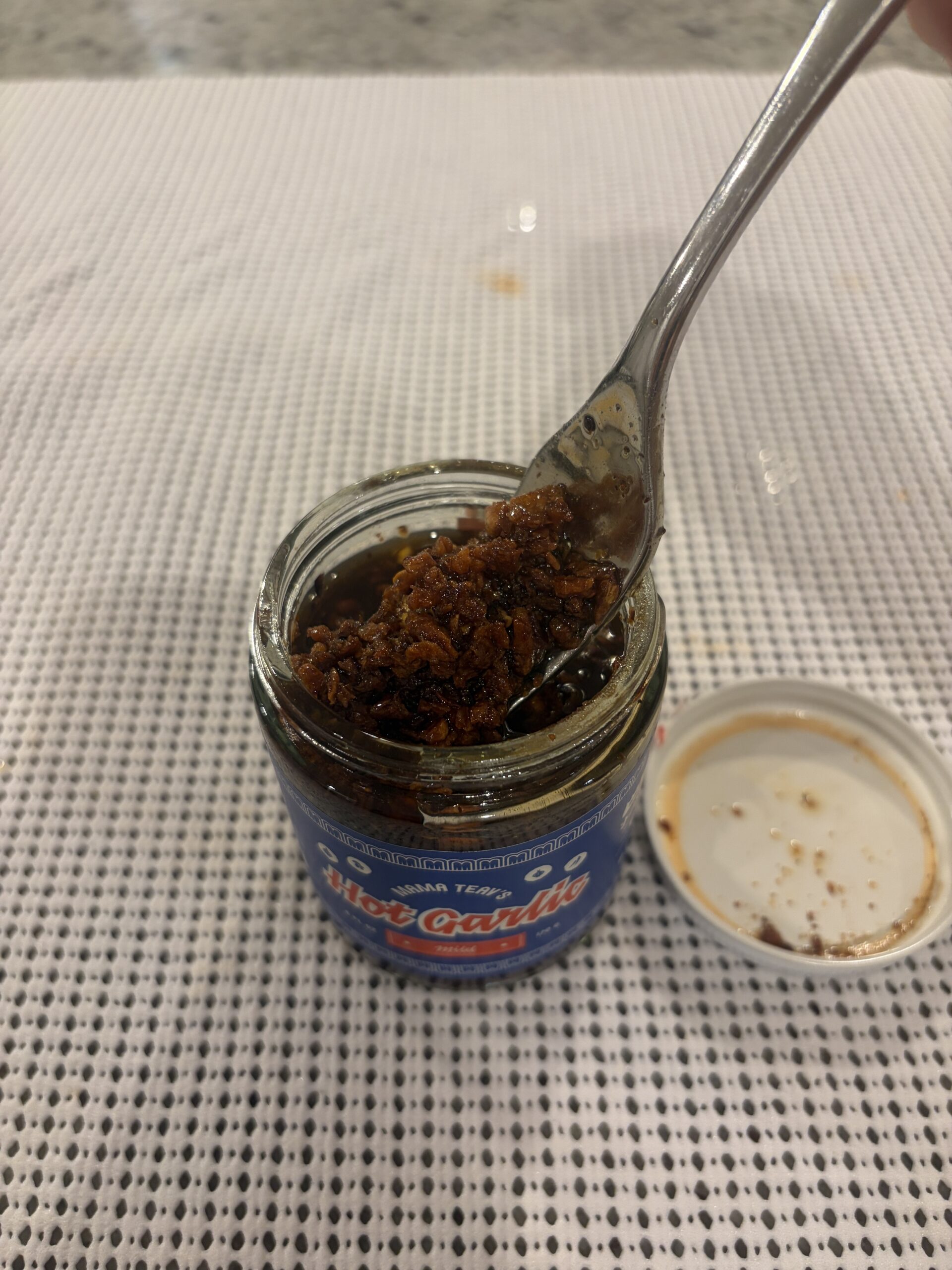 Mama Teav's Mild chili crisp fork pull showing crunchy garlic bits — Flavor Index Lab