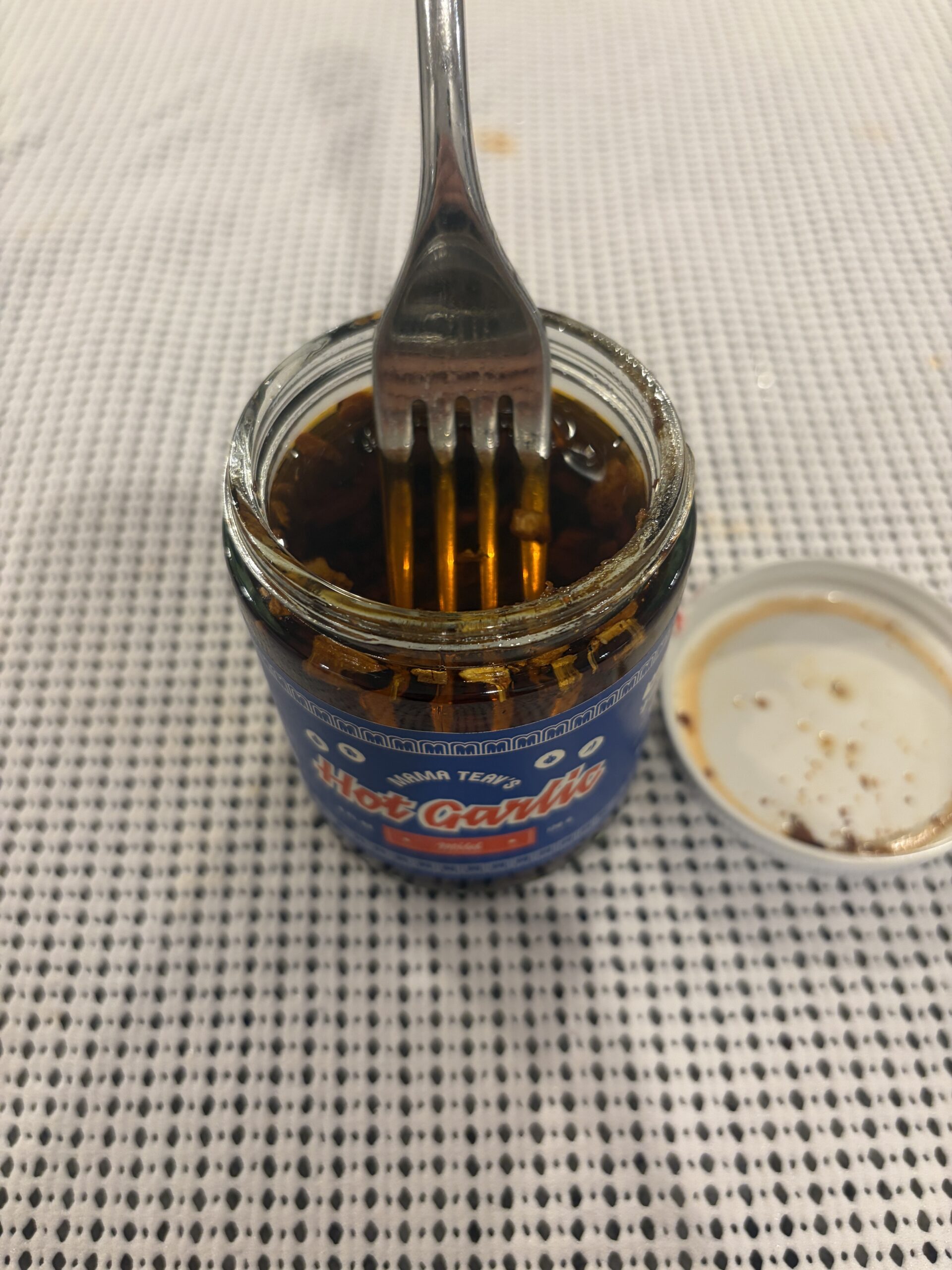 Fork resting on Mama Teav's Mild chili crisp solids — Flavor Index Lab