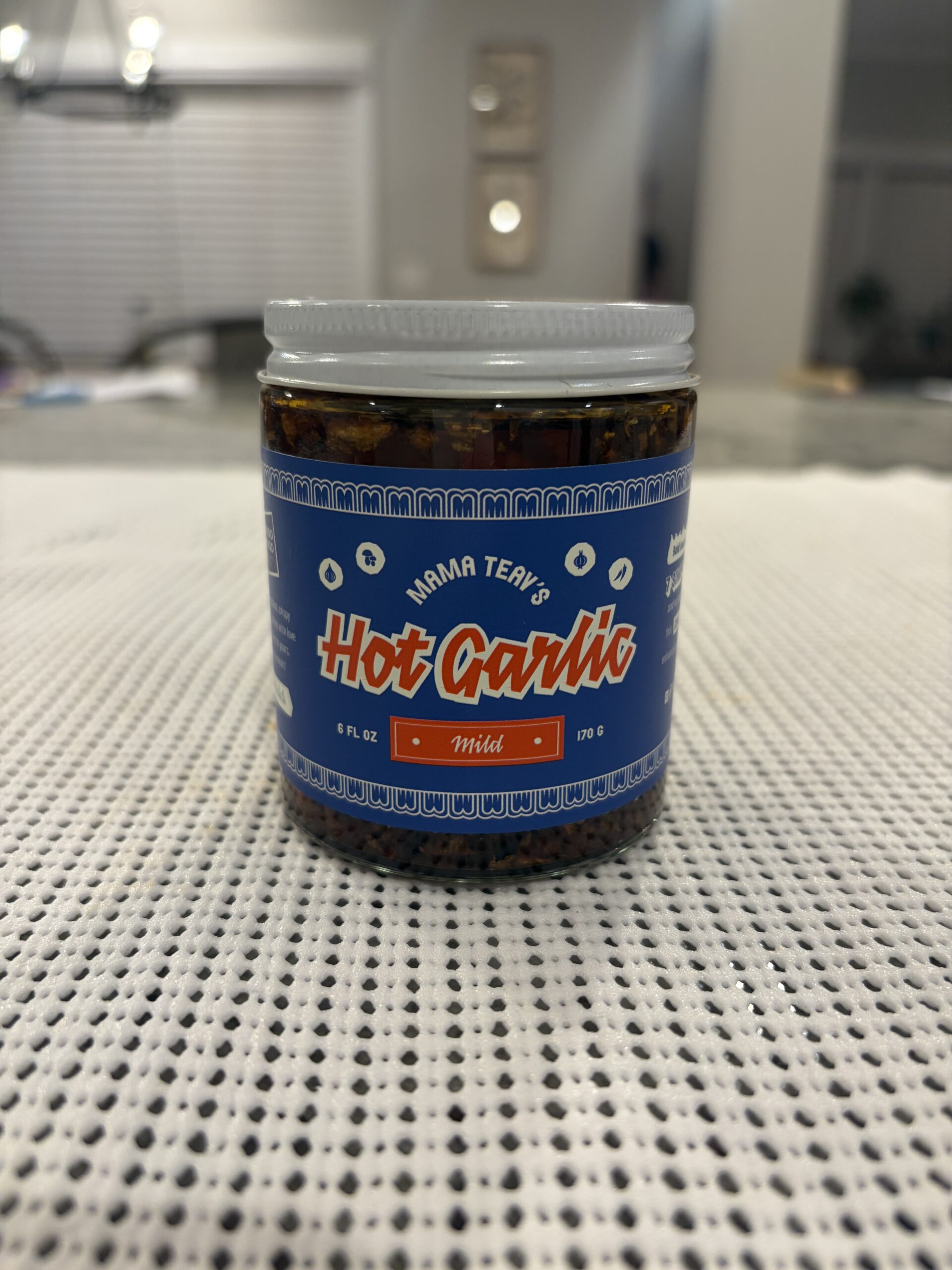 Mama Teavs mild chili crisp review jar showing brand label and heat rating — Flavor Index Lab