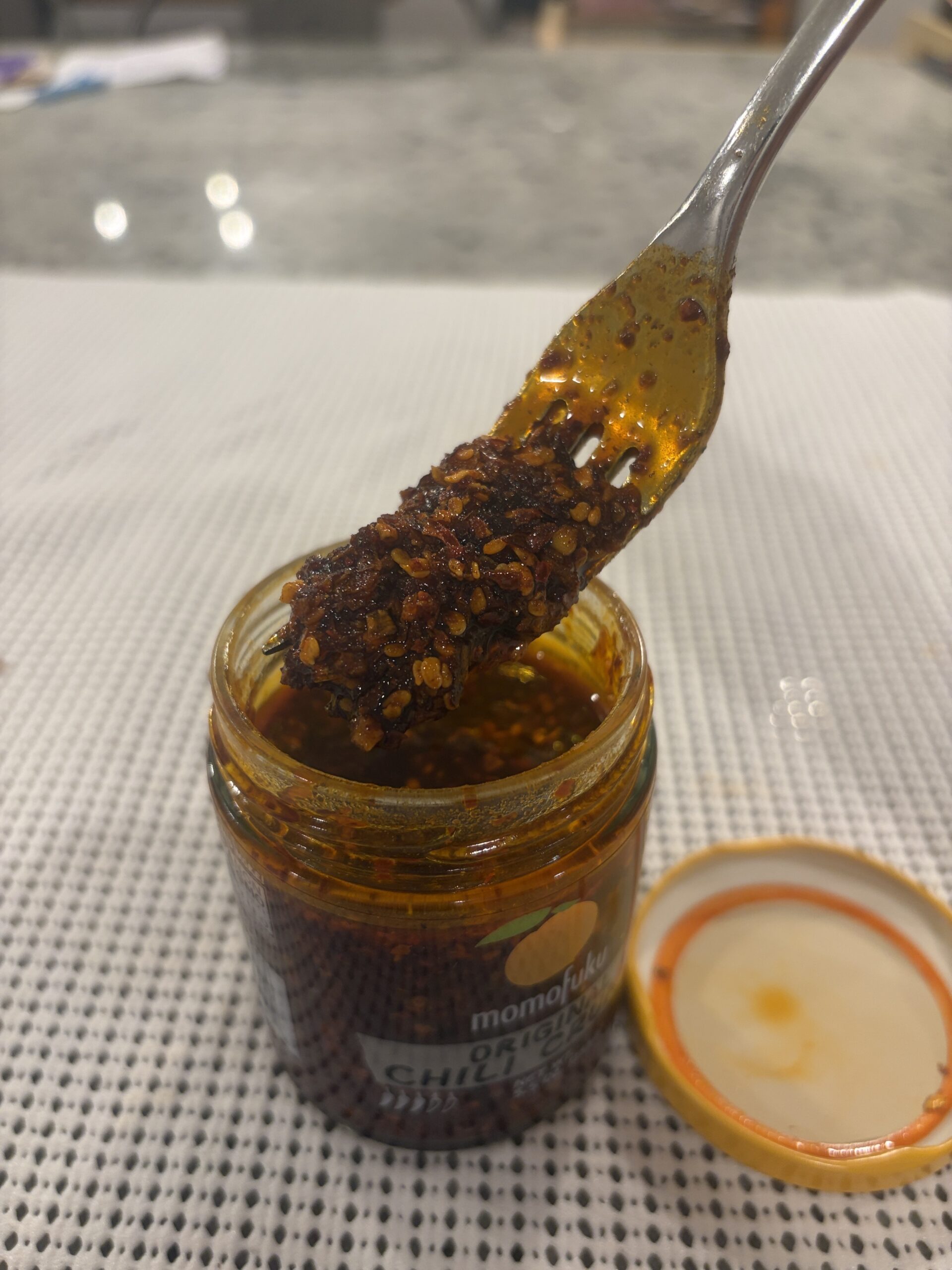 Momofuku Chili Crunch new batch fork pull showing thick syrupy consistency — Flavor Index Lab
