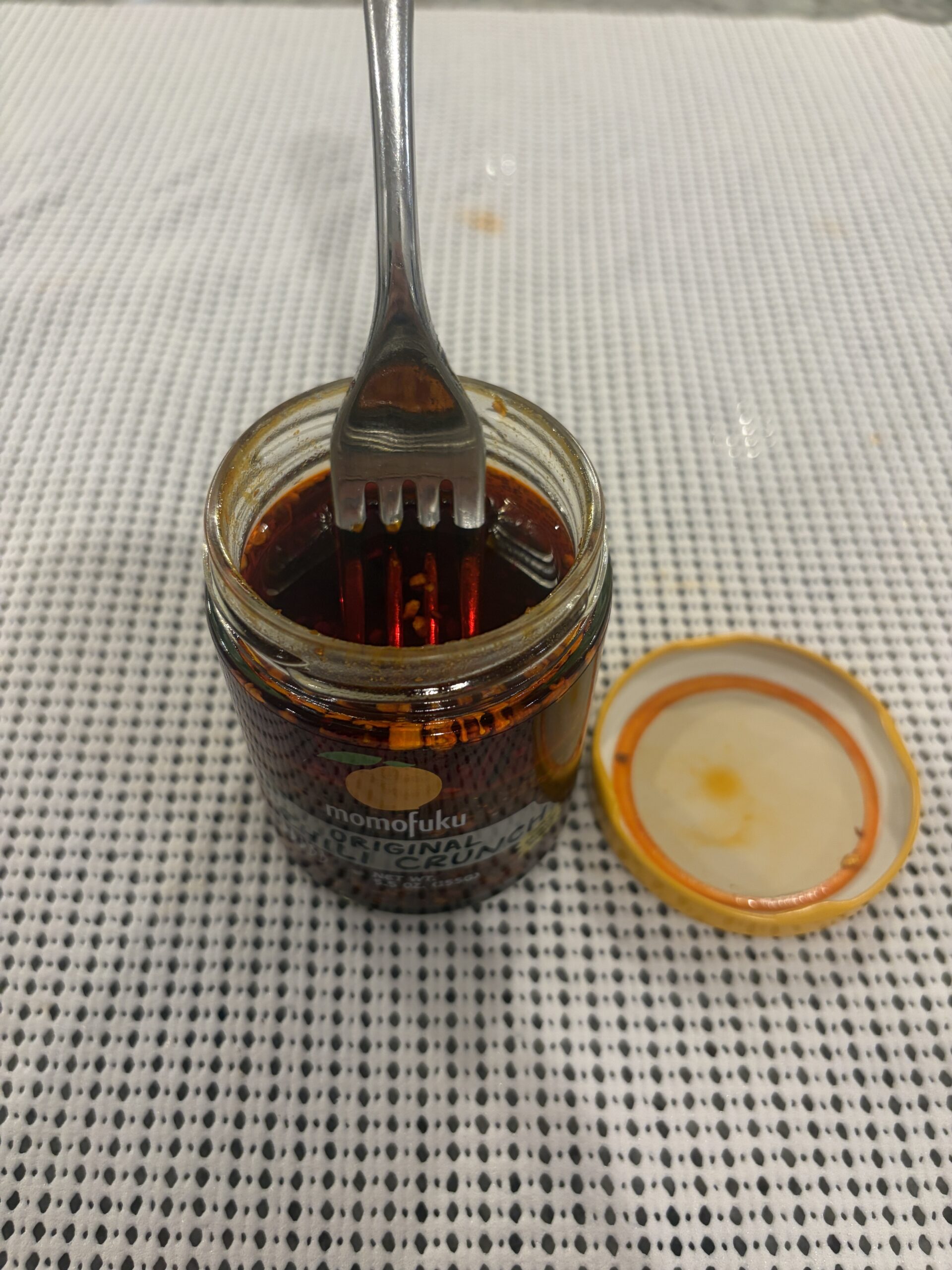 Fork resting on Momofuku Chili Crunch new batch solids — Flavor Index Lab