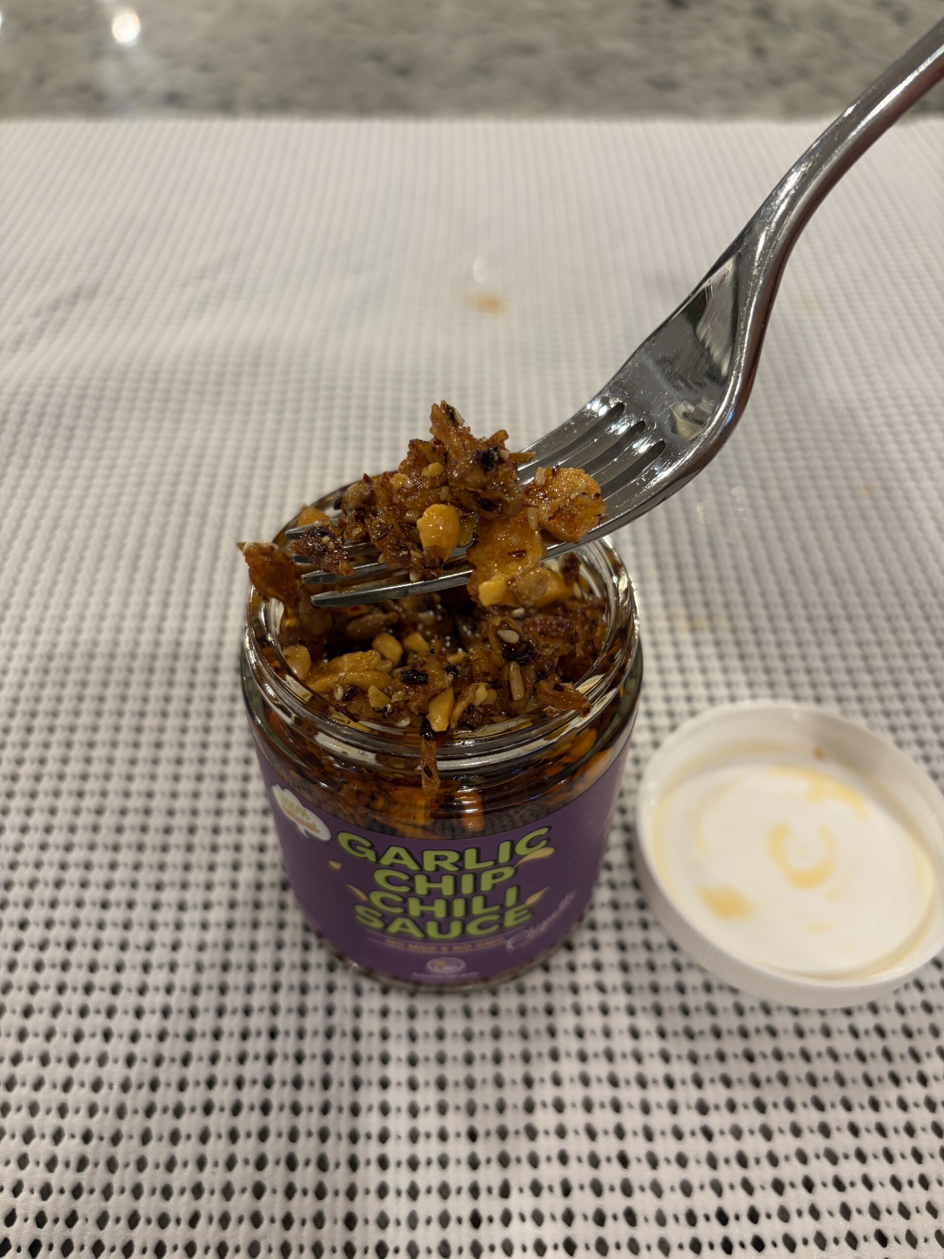 Sauce Up chipotle garlic chip fork pull showing thick honey-bound bits — Flavor Index Lab