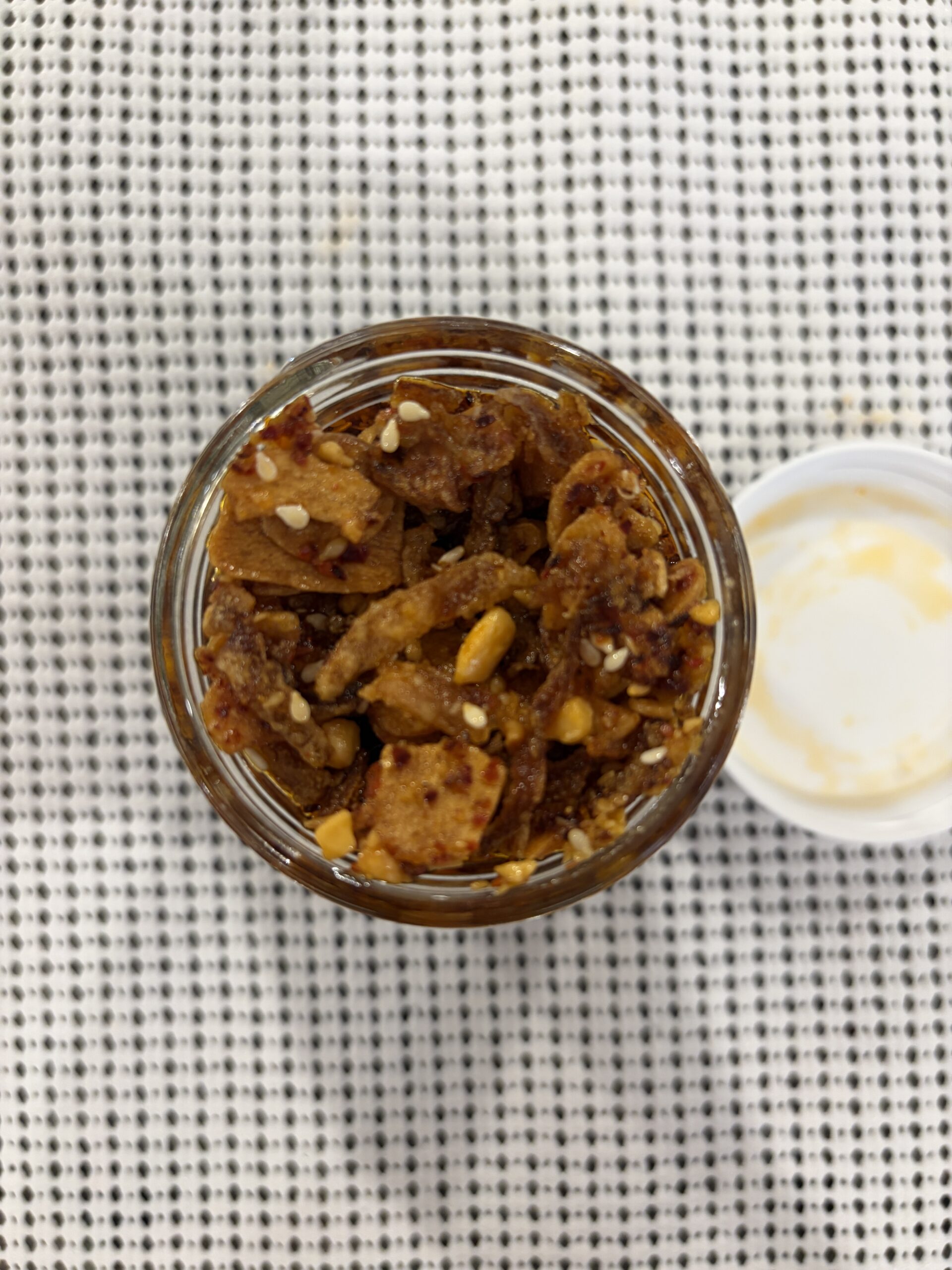 Sauce Up NYC garlic chip chili sauce open jar showing garlic chips and sesame — Flavor Index Lab