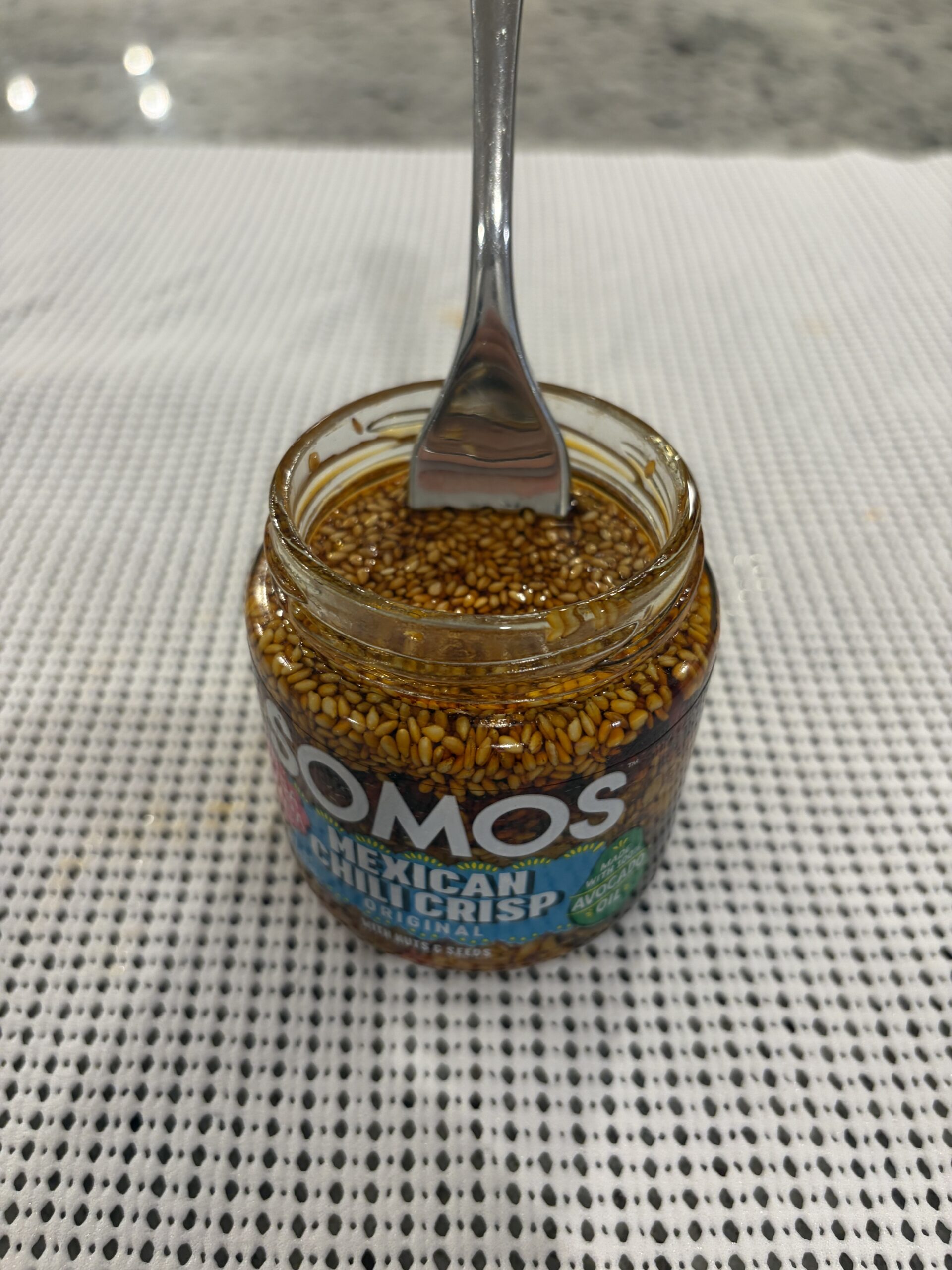 Fork resting on SOMOS Mexican Chili Crisp seed solids — Flavor Index Lab