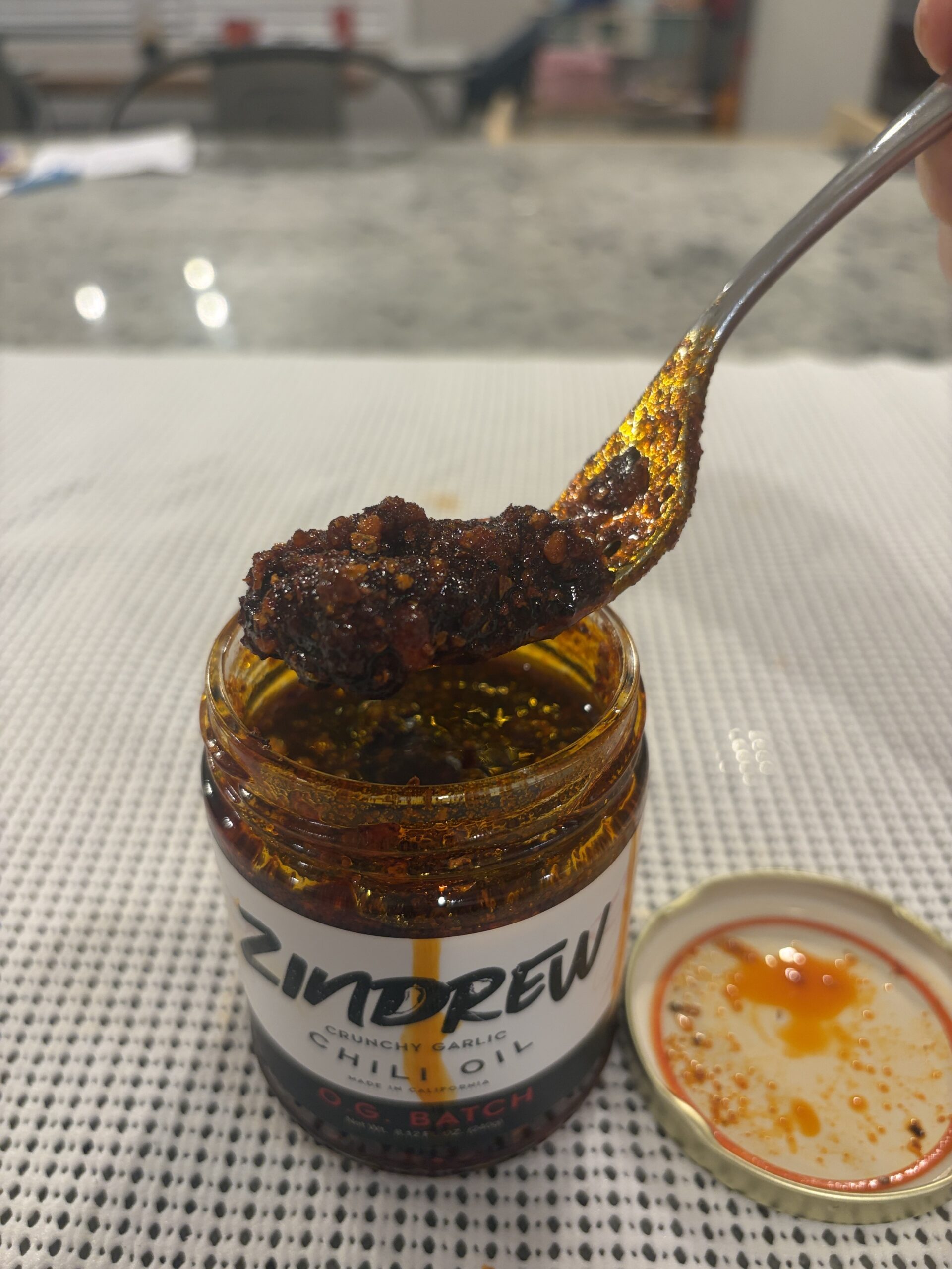 ZINDREW chili oil fork pull showing fine bits and oil — Flavor Index Lab