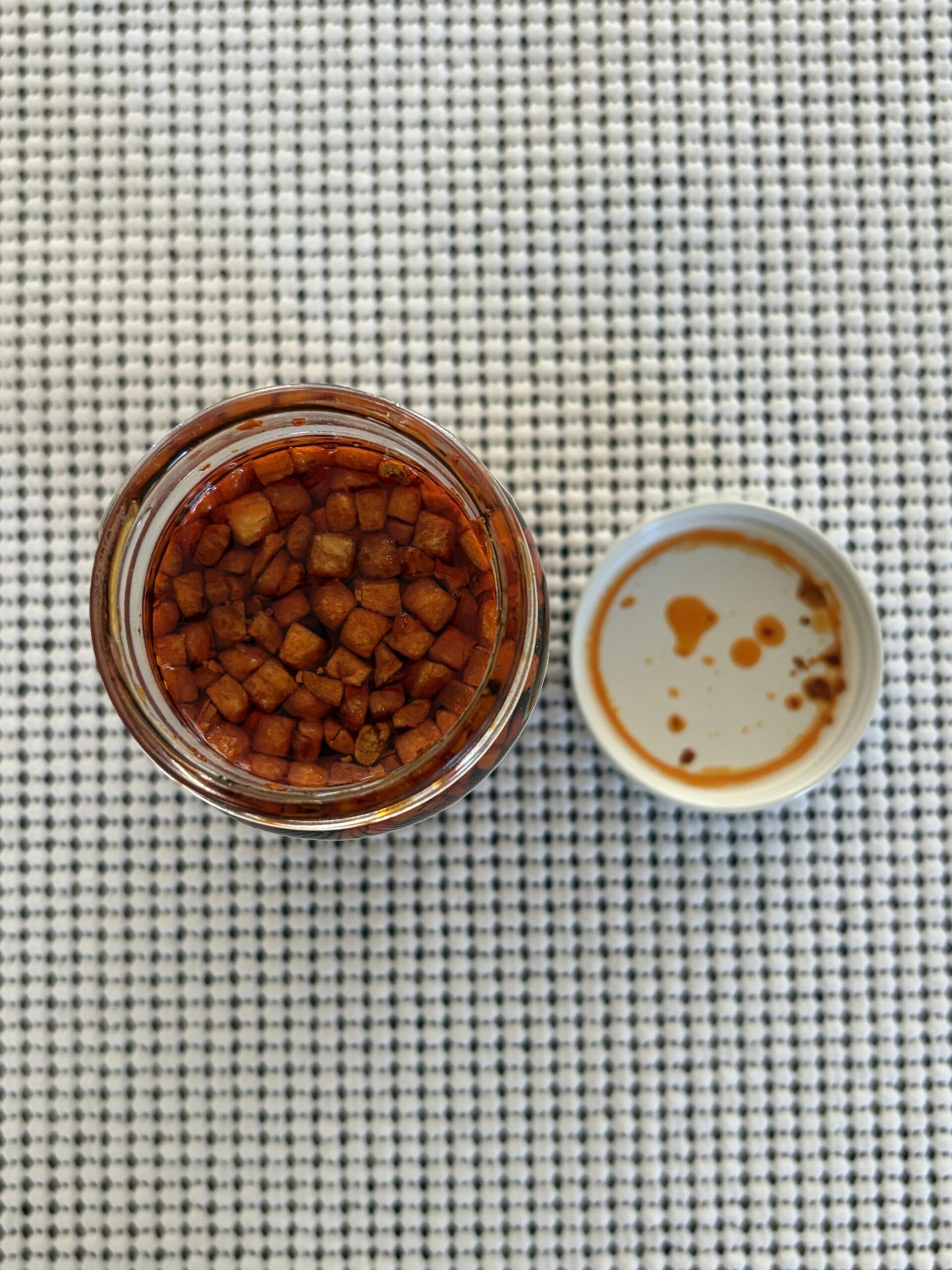Hot Boi Chili Oil Mild open jar with garlic chunks on top — Flavor Index Lab