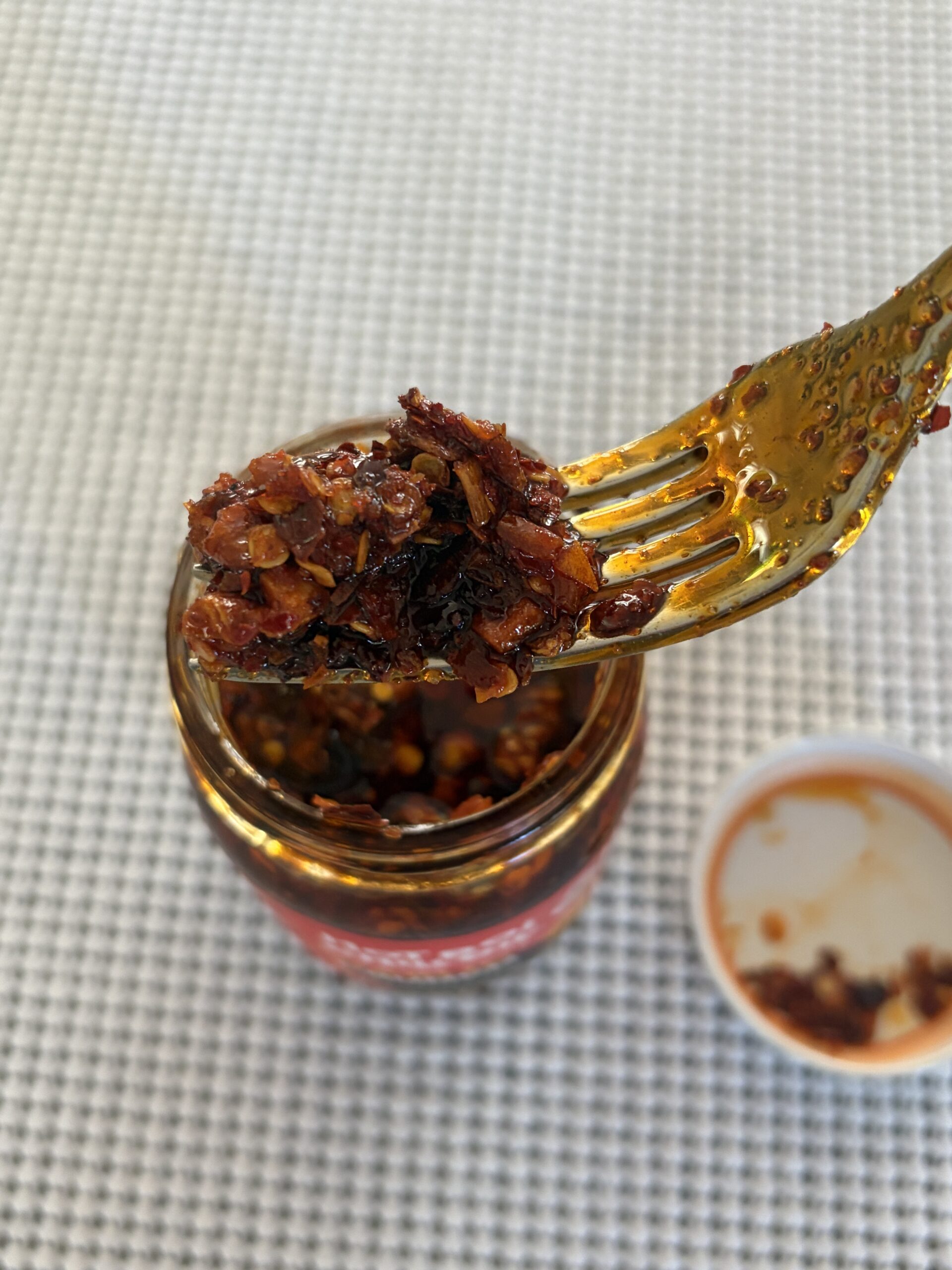 Hot Boi Chili Oil Fire fork pull showing chili bits and red oil — Flavor Index Lab