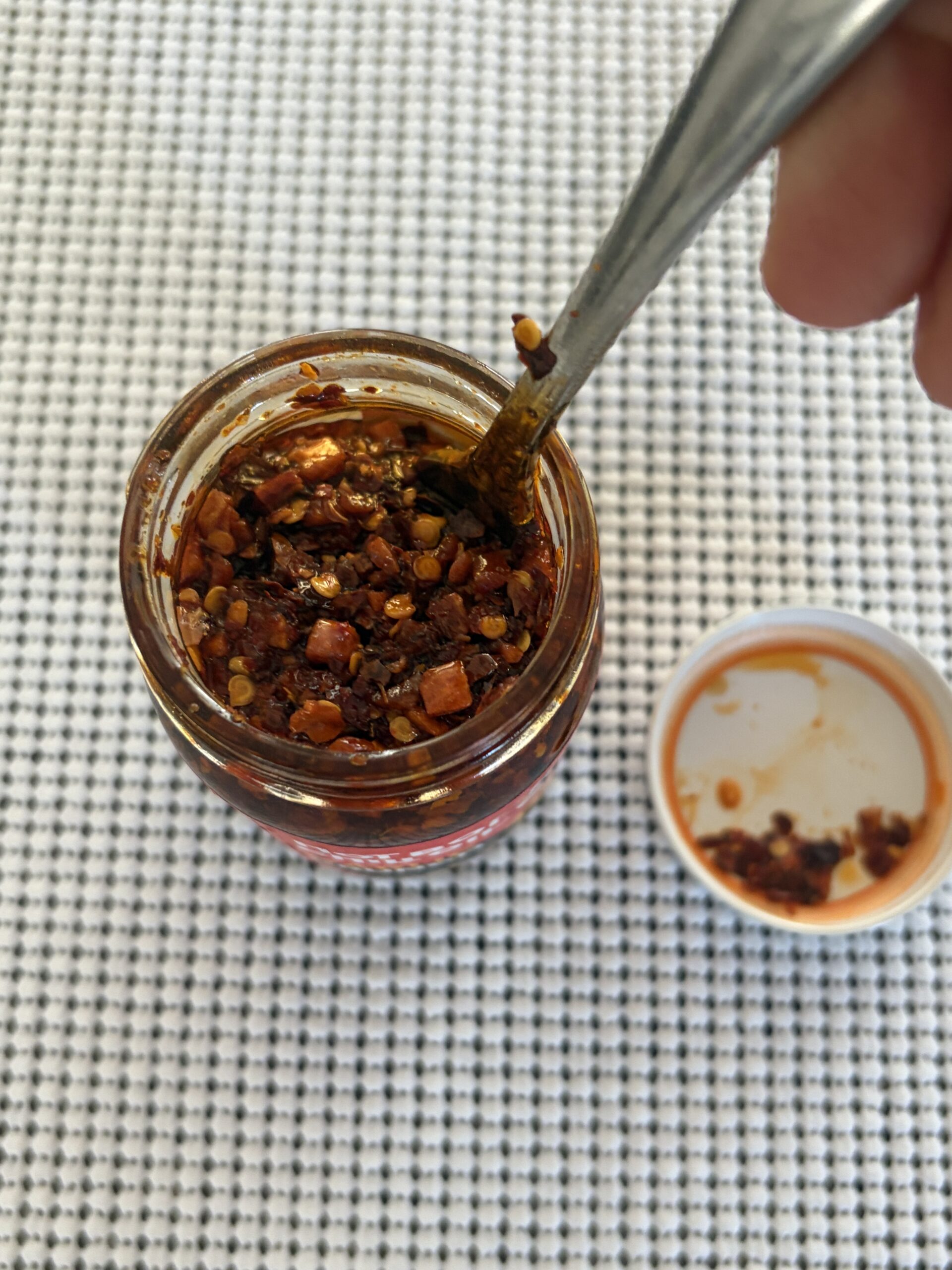 Hot Boi Chili Oil Fire after stirring, showing chili pieces, seeds, and garlic — Flavor Index Lab