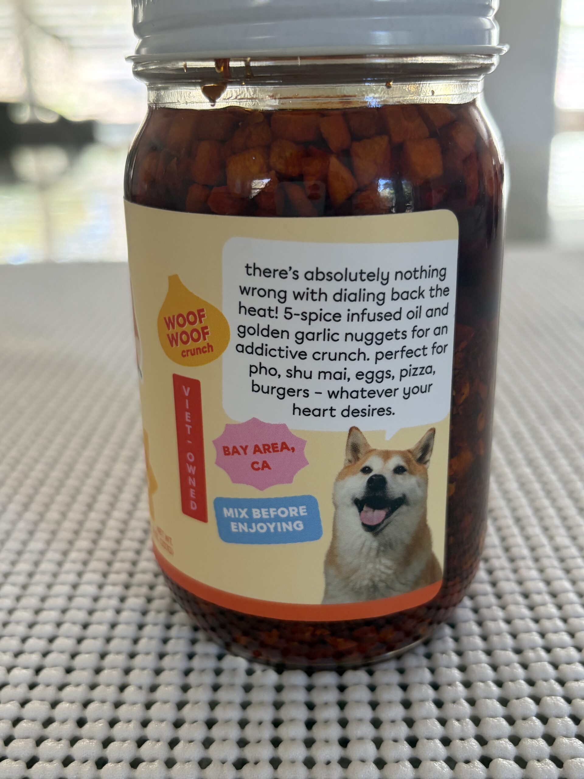 Hot Boi Chili Oil Mild jar at rest with garlic chunks settled above the label — Flavor Index Lab