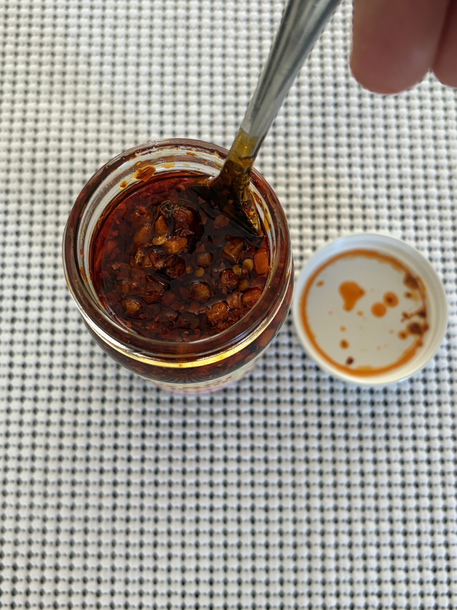 Hot Boi Chili Oil Mild after stirring, showing seeds, chili flakes, and garlic — Flavor Index Lab