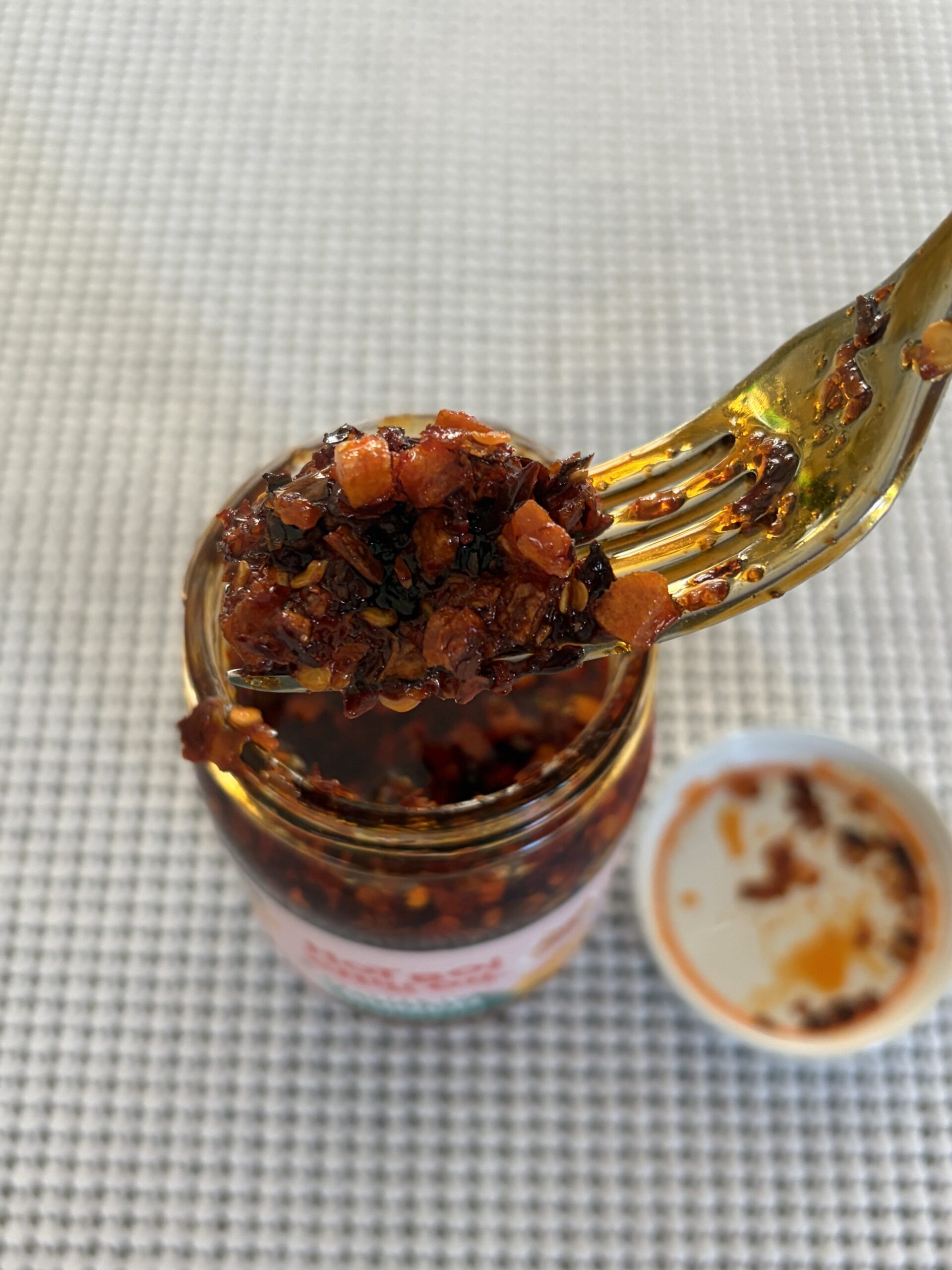 Hot Boi Chili Oil OG fork pull showing garlic chunks and red oil — Flavor Index Lab